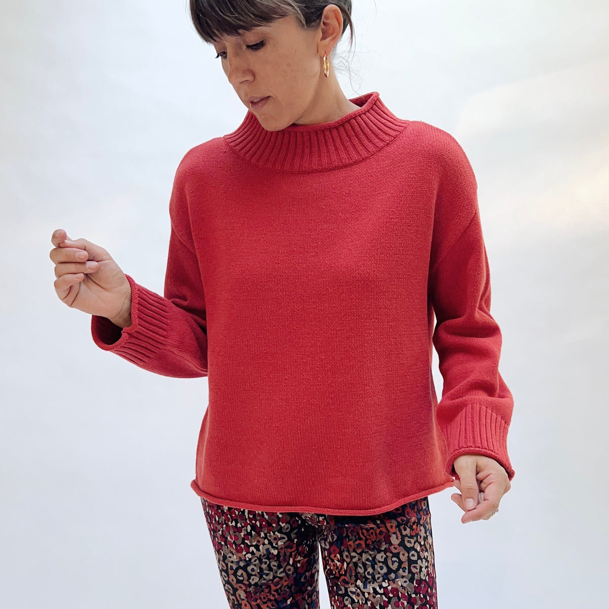 Habitat Fireside Cabin Sweater in Sienna, front view showing the mock neck collar and deep ribbed cuff detail in sienna red
