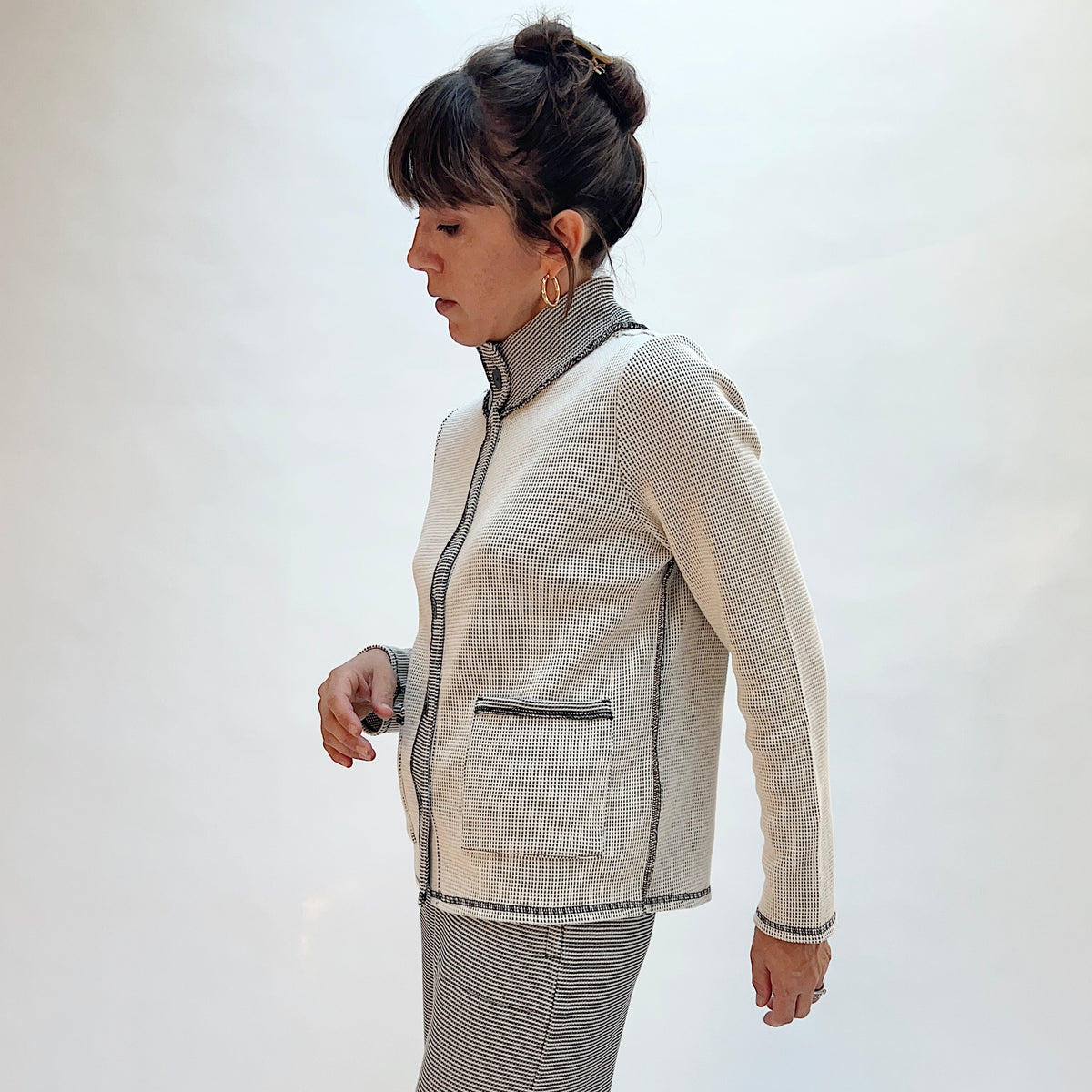 Habitat Opposites Attract Jacket in Winter White, side view showing the front patch pocket and contrast trim detail in grid-textured thermal knit
