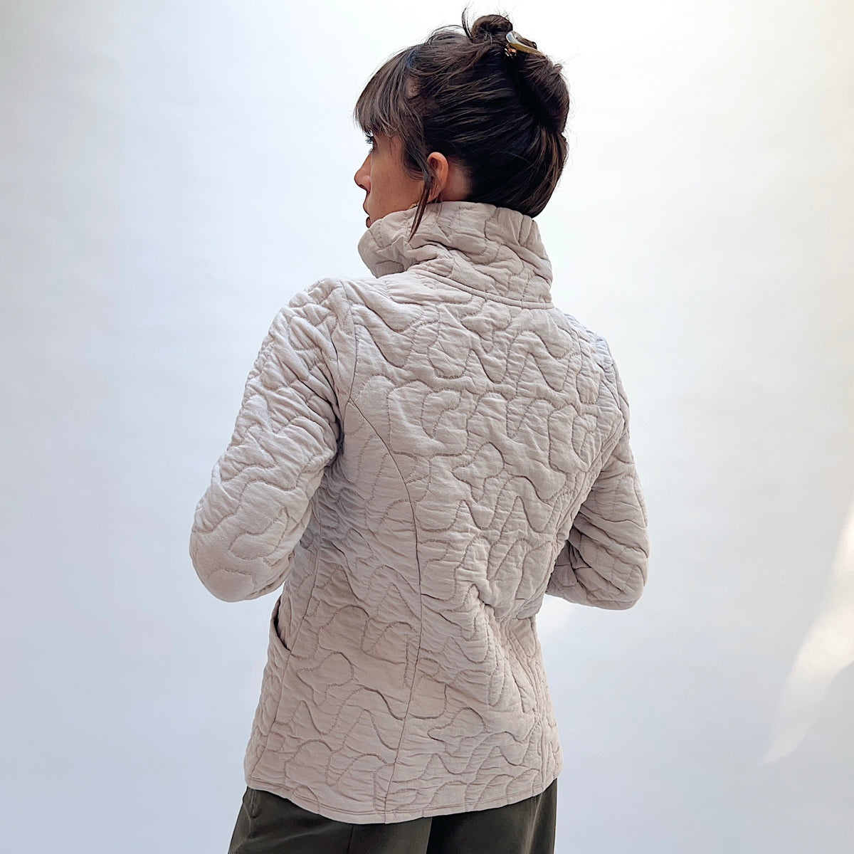 Habitat Cascade Quilted Coat in Dove, back view showing the princess seam construction and organic quilting pattern in dove
