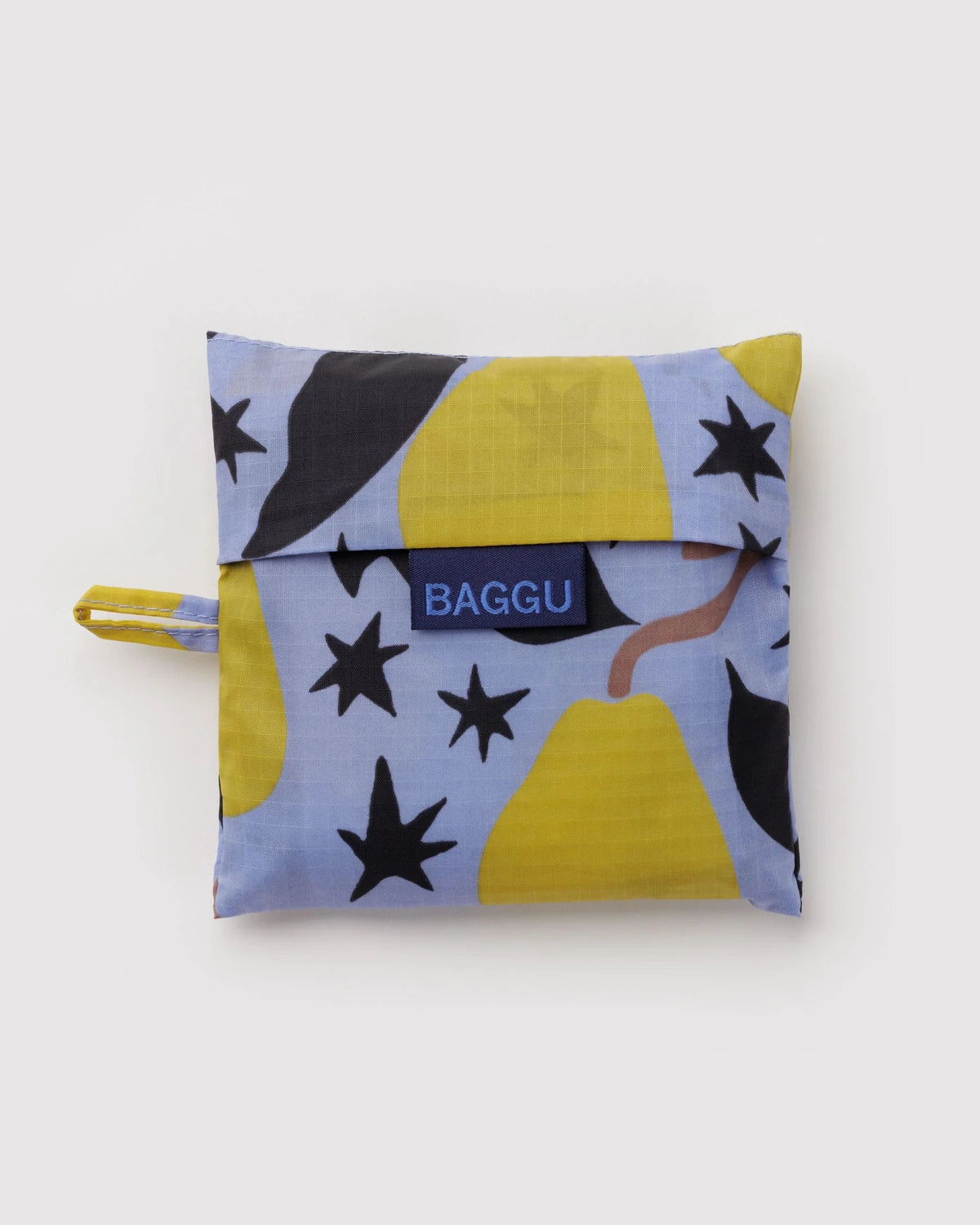 BAGGU Standard Baggu in Golden Pears, folded into its matching pear-print pouch with a visible BAGGU label.
