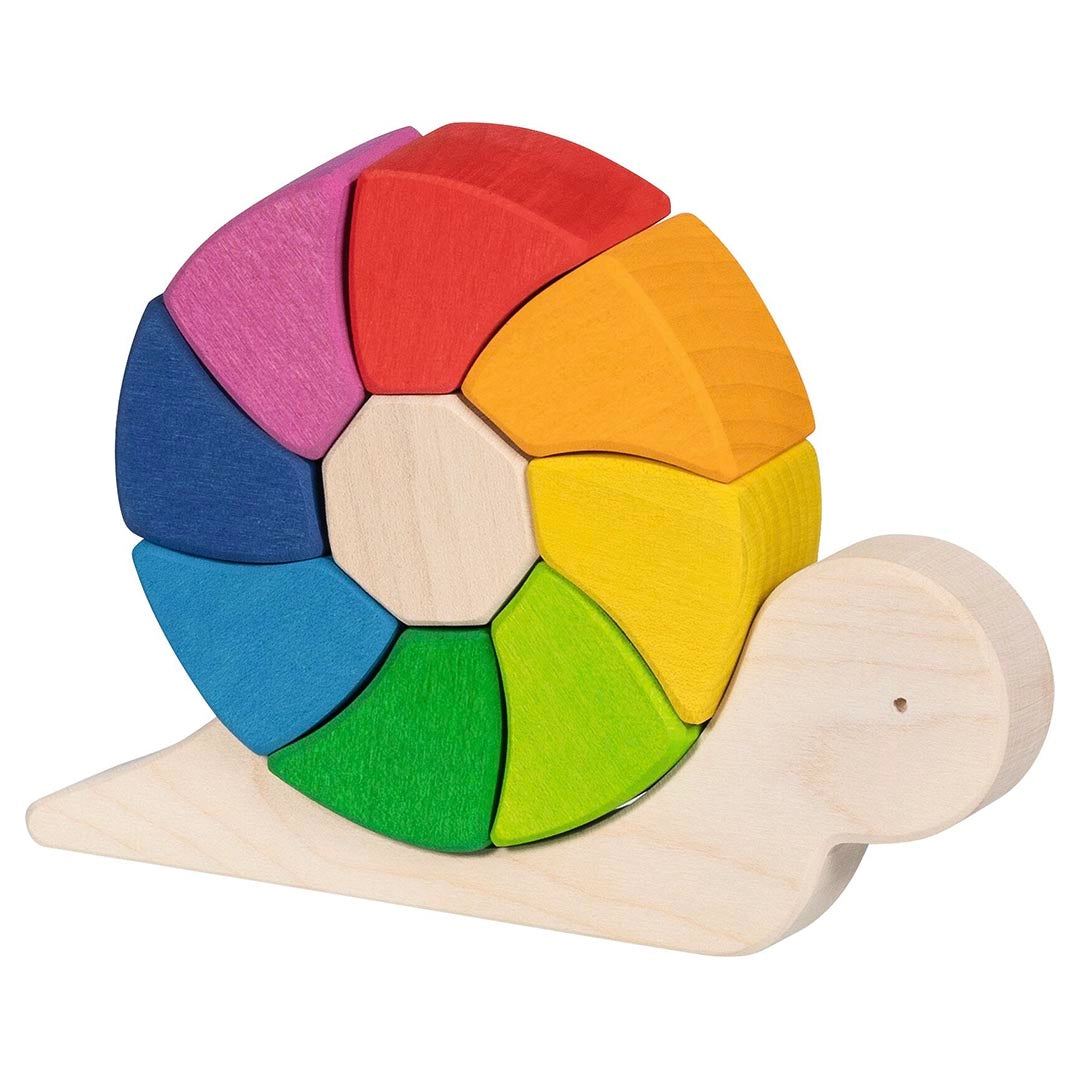 Goki Sassy Snail Puzzle fully assembled on a white background, showing a natural wood snail body with all 9 rainbow-colored wedge-shaped building blocks fitted into the circular shell in pink, red, orange, yellow, green, lime, teal, blue, and a natural wood octagon center piece