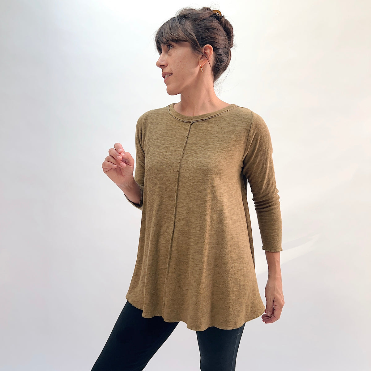 North Star Base Shorter High Low Double Cotton Tee in Olive, front three-quarter view showing the A-line swing silhouette, 3/4 sleeves, and center front seam in olive
