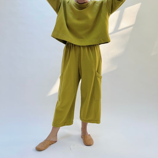 Front view of Pasha Fleece Pant in Chartreuse, showing the gathered elastic waistband, wide legs, and thigh patch pockets.
