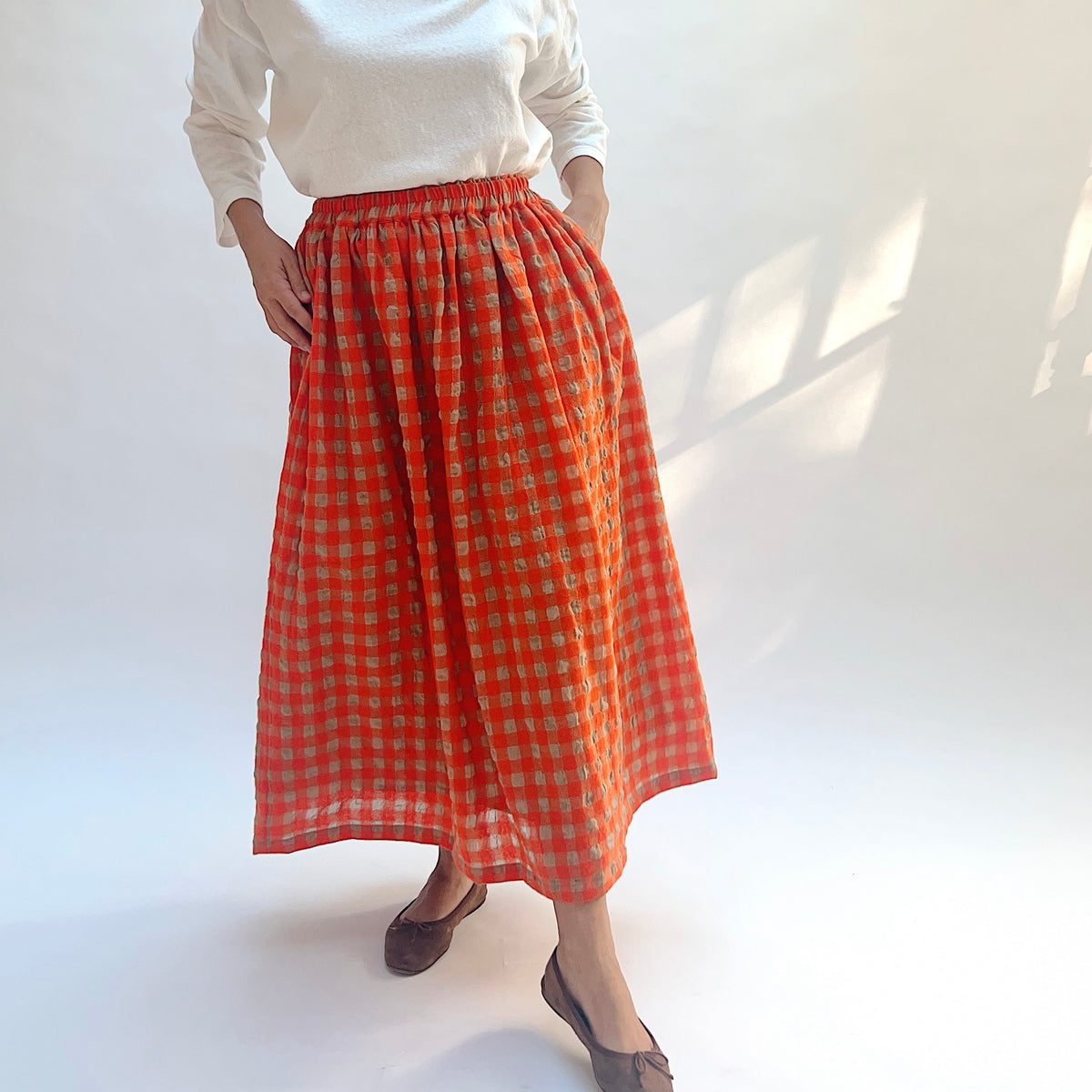 Ichi Antiquités Gingham Wool Check Skirt in Beige & Orange, angled front view showing the fullness of the skirt.
