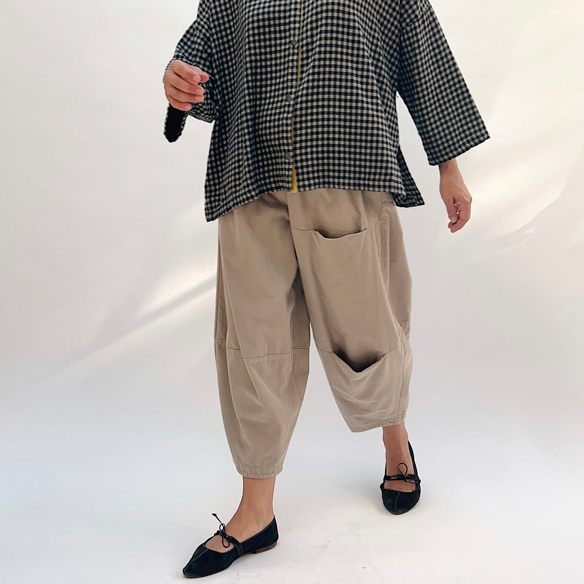 Eleven Stitch Corduroy Three Pocket Pant in Fennel, front view showing the two stacked patch pockets on one leg and one patch pocket on the other, styled with a gingham check shirt
