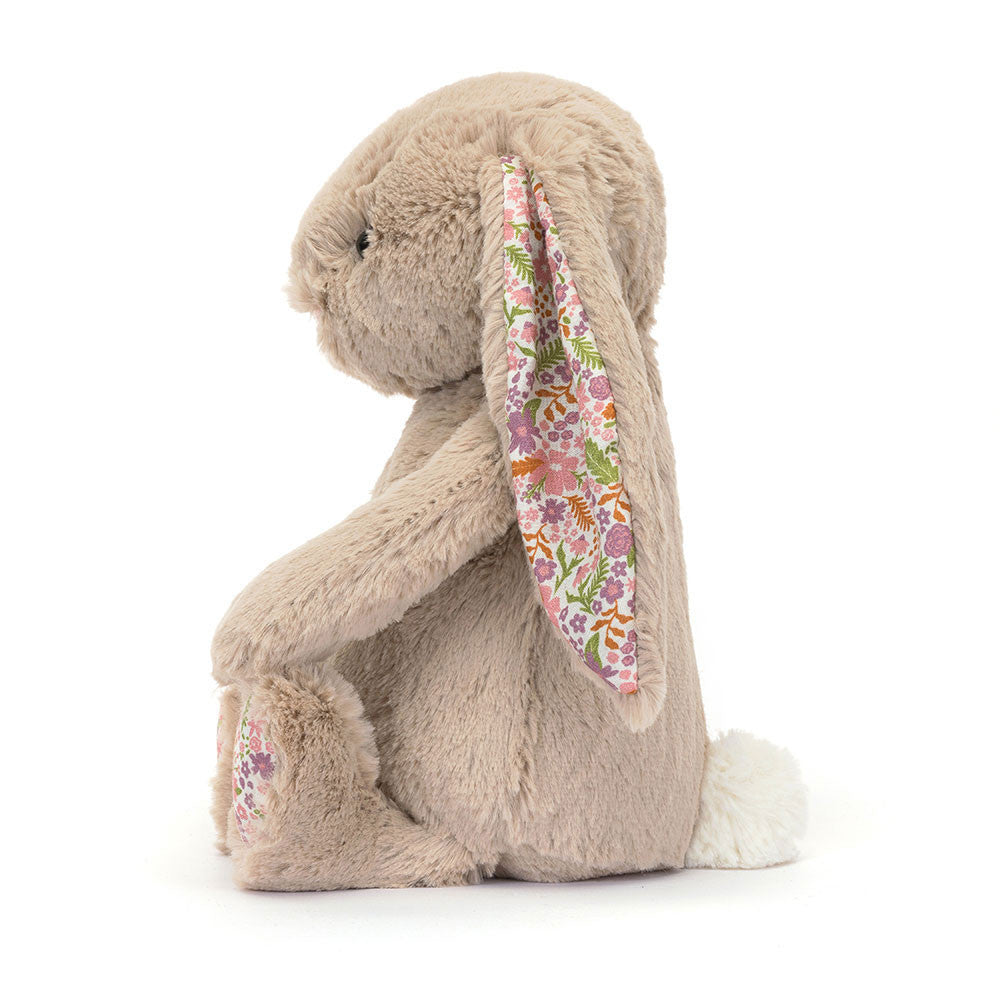 Jellycat Blossom Beige Bunny 'Petal' Original — side profile view showing the long floppy ear with white floral lining in pink, purple, and orange, beige textured fur, floral paw pad, and white cotton tail, on a white background