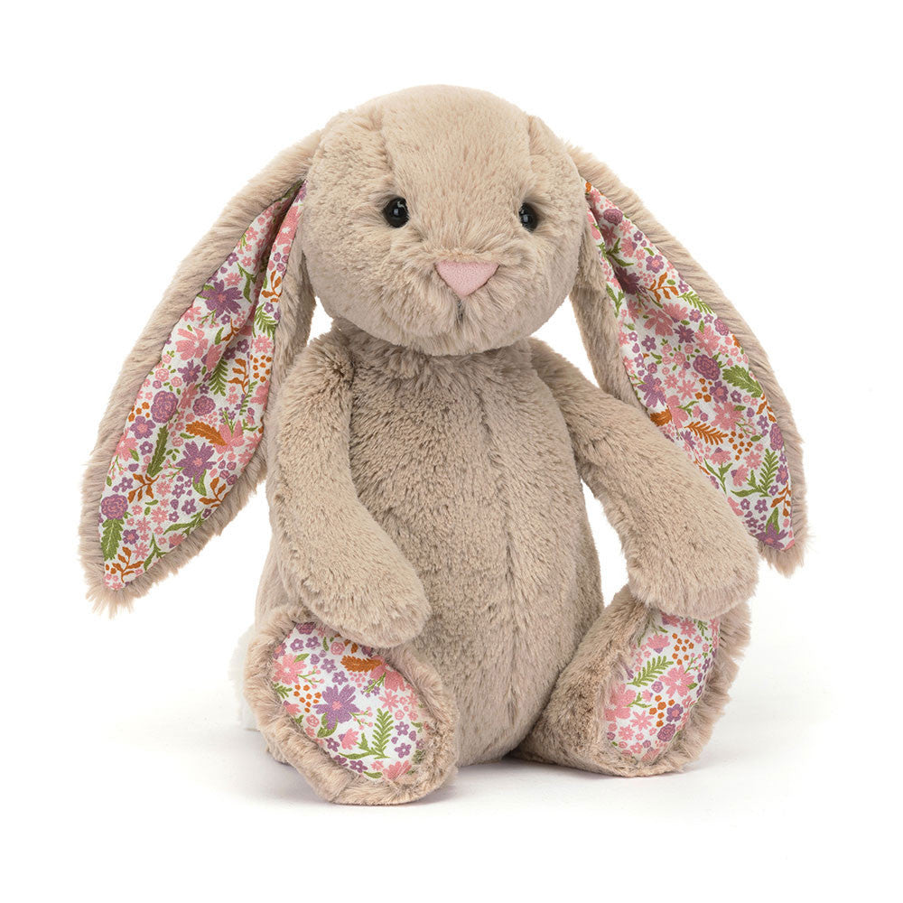 Jellycat Blossom Beige Bunny 'Petal' Original — a soft beige plush bunny seated upright with long floppy ears lined in a white floral fabric with pink, purple, and orange flowers and green leaves, a pink embroidered nose, black hard eyes, and matching floral paw pads, on a white background