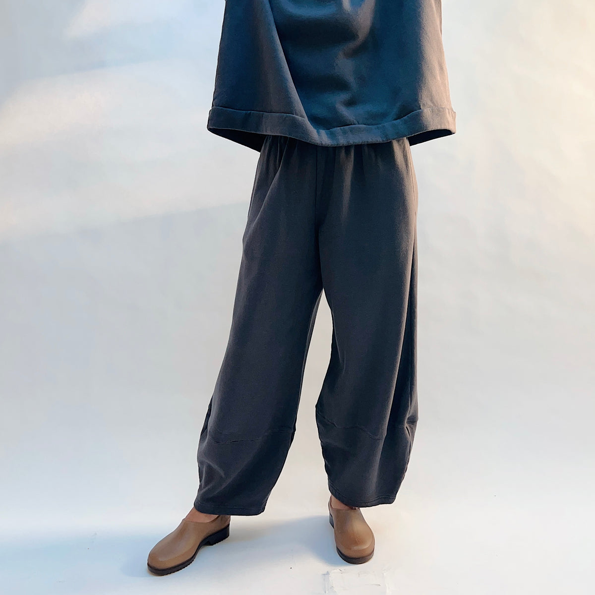 Front view of Bryn Walker Oliver Fleece Pant in Moonlight on a model, showing the loose legs tapering toward the ankles.
