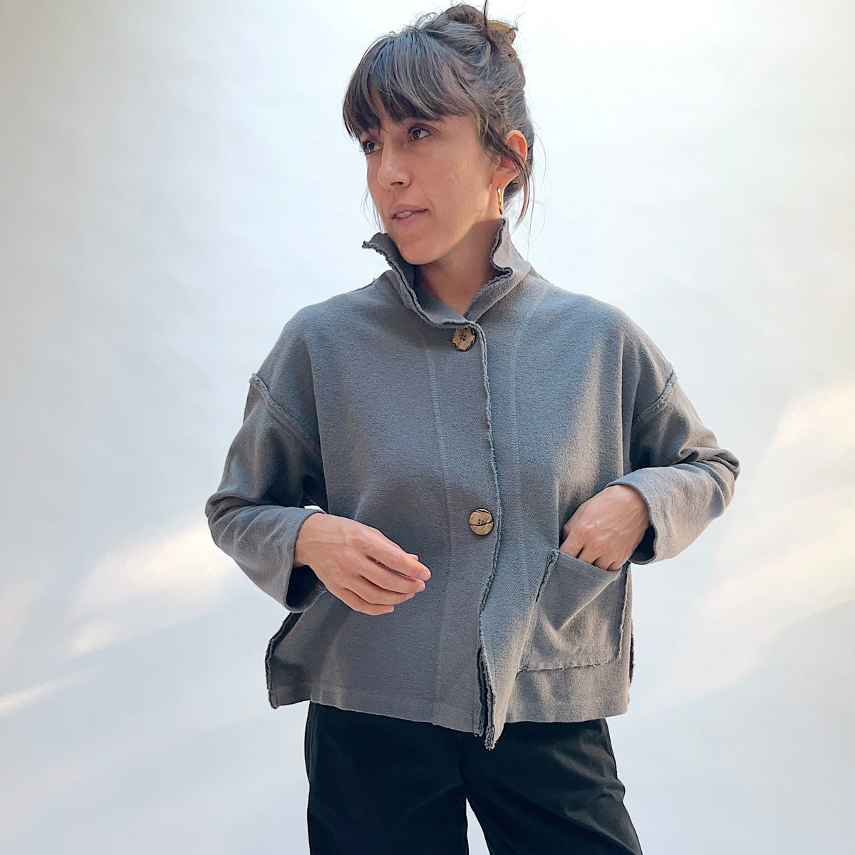 Eleven Stitch Funnel Jacket in Eiffel Tower, front view showing the funnel neckline, exposed seam detail, and front patch pockets in slate blue-gray cotton terry
