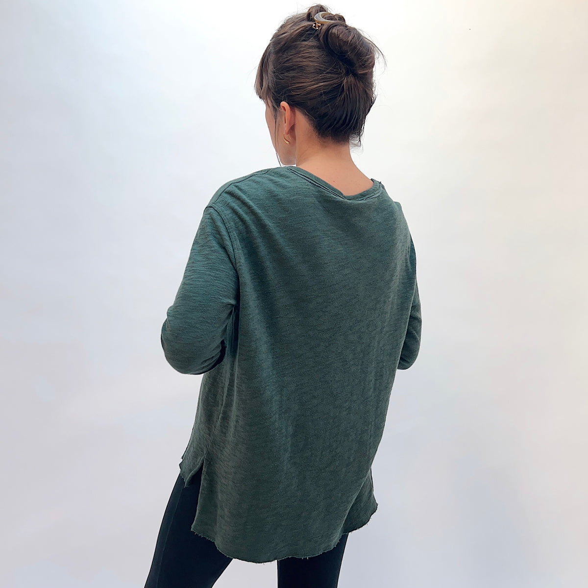 North Star Base Double Cotton Beach Tee in Konbu, back view showing the longer high-low hem and side slits in konbu green
