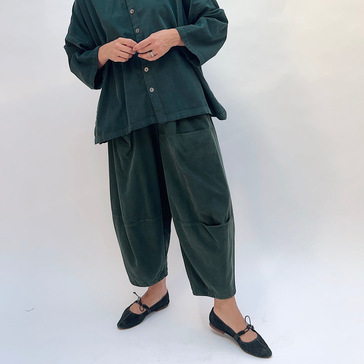 Eleven Stitch Corduroy Three Pocket Pant in Konbu, front view showing the wide-leg barrel silhouette and patch pockets in dark green fine-wale corduroy
