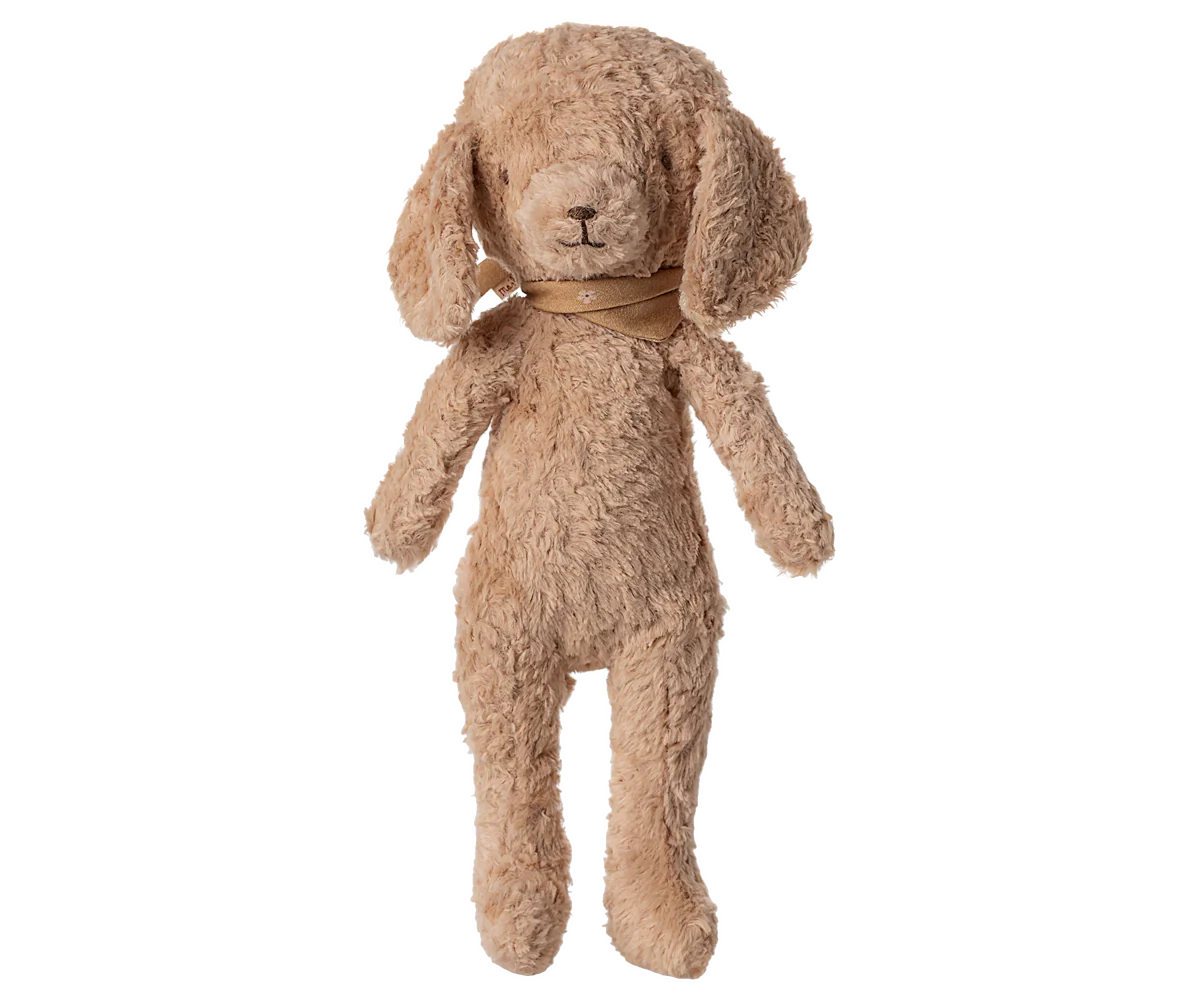 Maileg Poodle Dog in Dusty Powder on a white background — a soft curly-textured cotton and viscose stuffed poodle in warm dusty powder with floppy ears, embroidered nose, and a tonal satin ribbon at the neck
