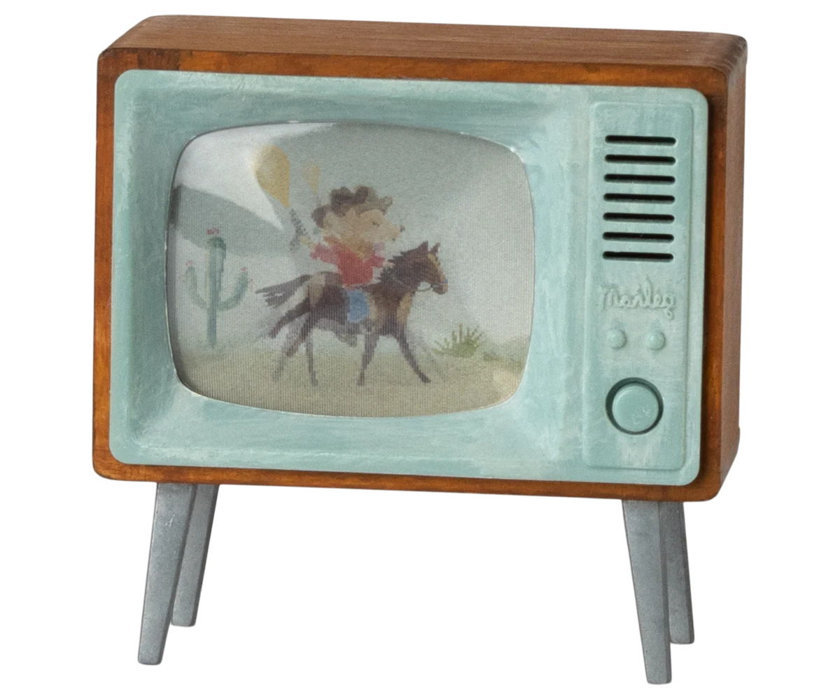 Maileg Mouse Television Set — miniature retro-style television with a walnut wood frame, mint green plastic surround, and a backlit screen showing an illustrated cowboy scene, on four angled legs
