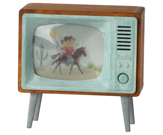 Maileg Mouse Television Set — miniature retro-style television with a walnut wood frame, mint green plastic surround, and a backlit screen showing an illustrated cowboy scene, on four angled legs
