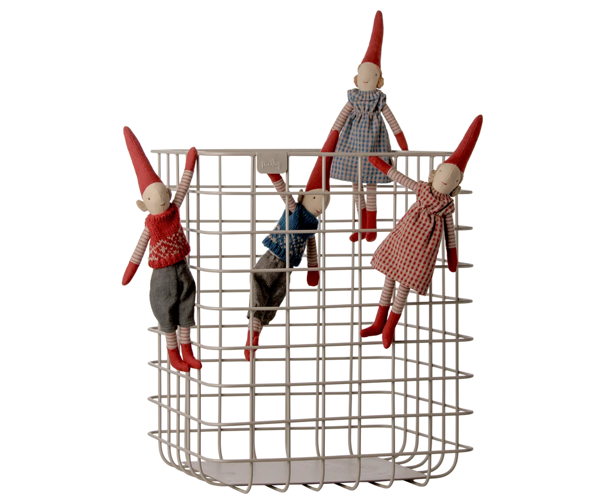 Blue-dress Maileg Pixy Girl perched at the top of a wire basket with three other Christmas Pixies in red hats.
