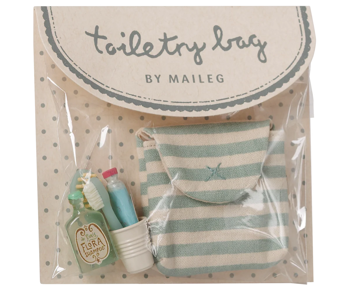 Maileg Toothbrush Set in Blue Striped Bag — product in original Maileg packaging showing the blue and cream striped cotton bag with miniature accessories including a Flora Shampoo bottle, toothbrush, toothpaste tube, and ribbed water cup
