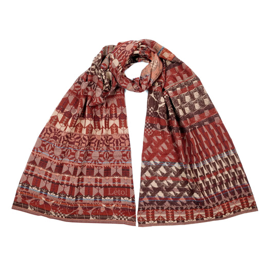 Létol Come Scarf in Burgundy & Brown, draped and loosely knotted against a white background, showing a reversible Jacquard-woven organic cotton scarf in chocolate brown, burgundy, crimson, taupe, and dusty pink — one side featuring geometric botanical and medallion motifs in horizontal bands, the other showing a bold diamond and chevron houndstooth pattern — with a woven Létol label visible at the lower left
