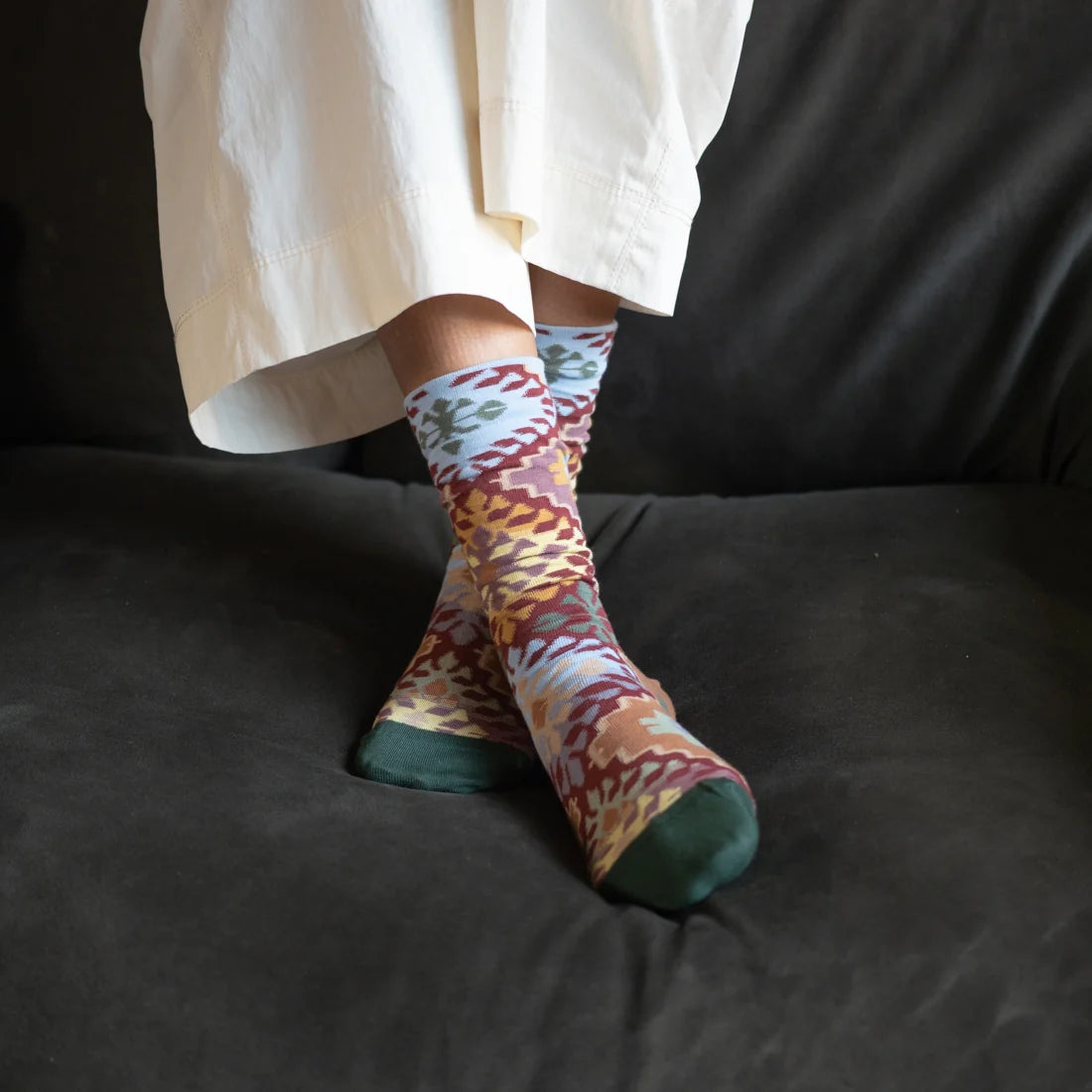 Bonne Maison Le Tapis Multicolor Socks styled on feet showing the crew length and all-over kilim-inspired multicolor geometric pattern
