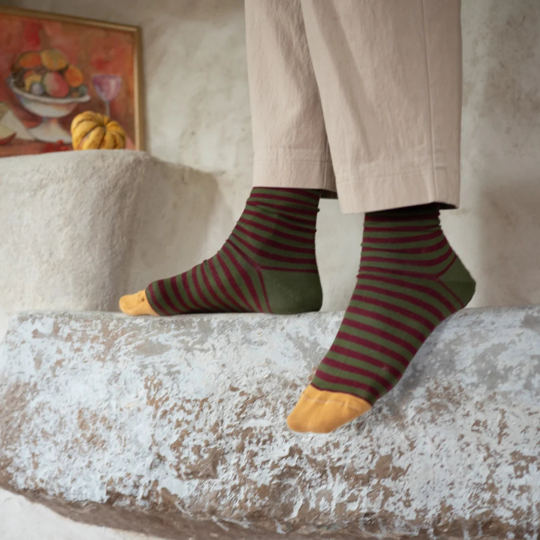 Bonne Maison Cypress Stripe Socks styled on feet showing the crew length, cypress green and burgundy horizontal stripes, and mustard toe
