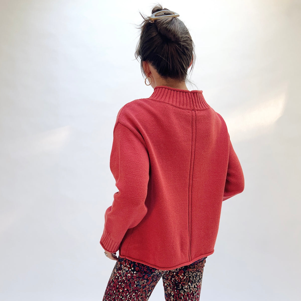 Habitat Fireside Cabin Sweater in Sienna, back view showing the center back stitch detail and rolled hem in sienna red
