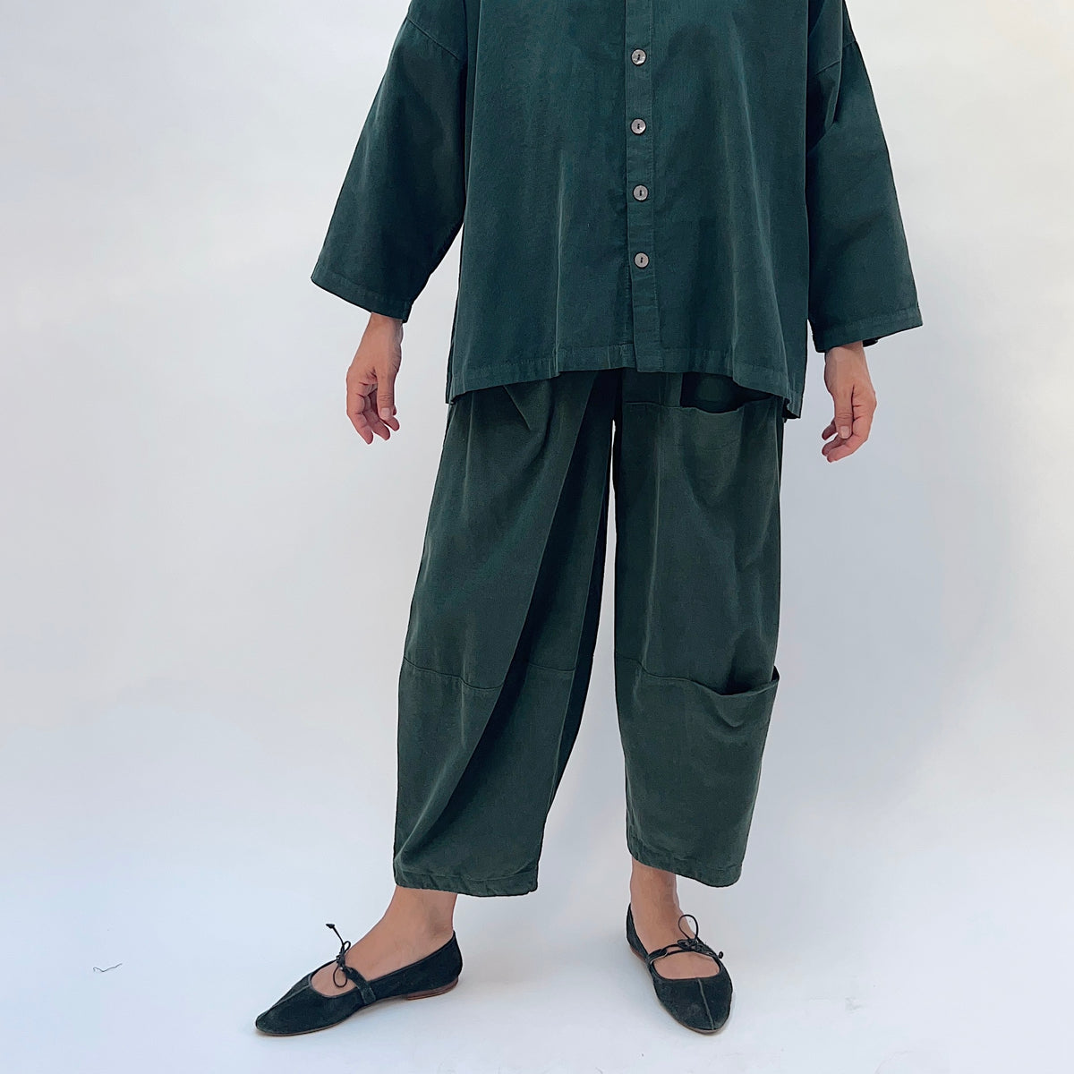 Eleven Stitch Corduroy Three Pocket Pant in Konbu, front view showing the full wide-leg silhouette and seam detail in dark green fine-wale corduroy
