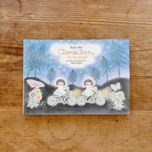 Cover of the book 'Chirri & Chirra: In the Night' featuring illustrations of two small figures on bicycles in a nighttime setting with stars and a full moon.