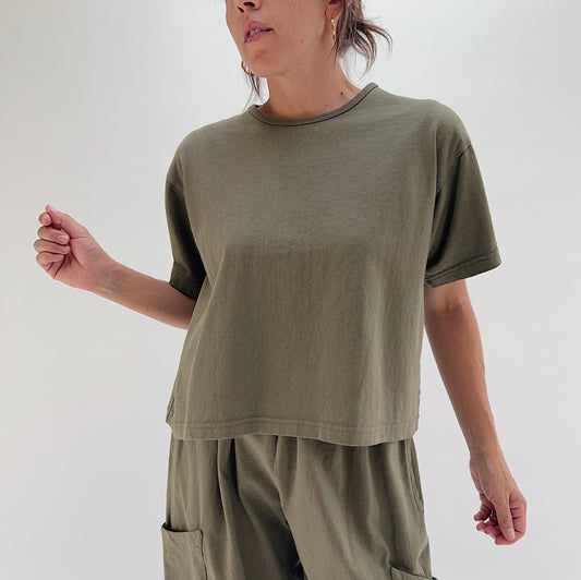 Three-quarter front view of model wearing Pacific Cotton jasper crop crew tee, showing heavyweight cotton texture, crew neckline, and straight cropped hem