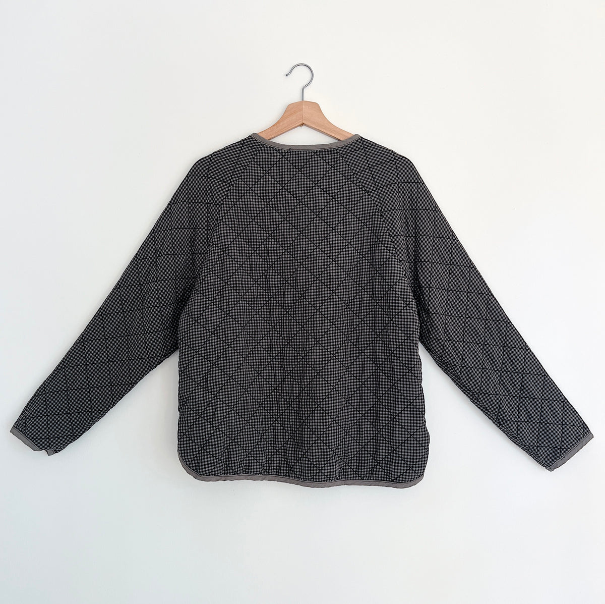 Cut Loose Easy Jacket in Iron Mini Check, back view on a hanger showing diamond quilting and long sleeves.
