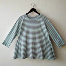 Load image into Gallery viewer, Green and white striped shirt on a hanger against a white wall
