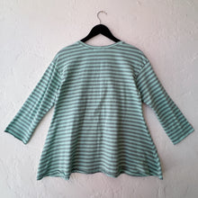 Load image into Gallery viewer, Green and white striped shirt on a hanger against a white wall
