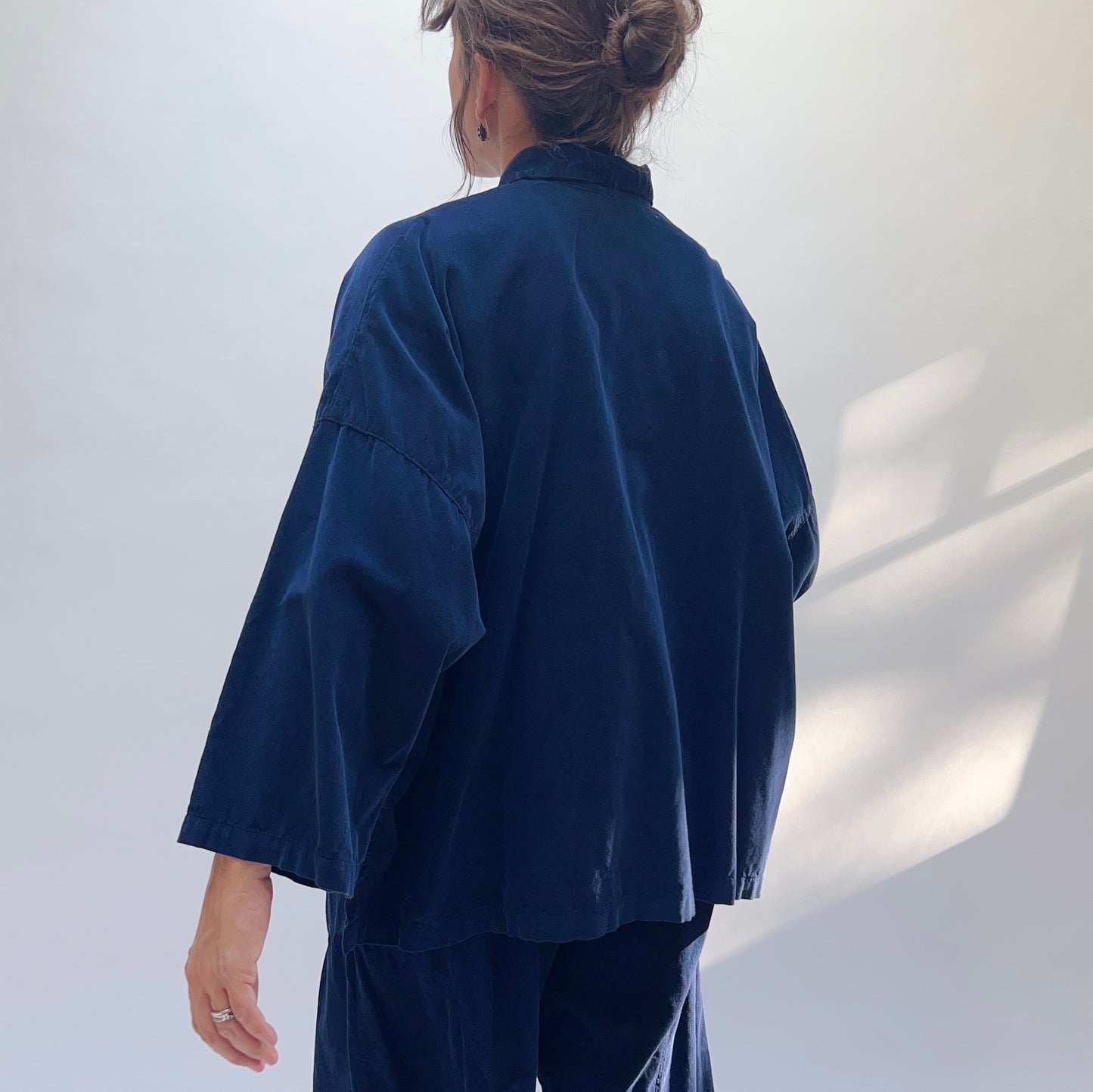 Back view of the Eleven Stitch Corduroy Big Shirt in Indigo, showing wide boxy cut and three-quarter sleeves