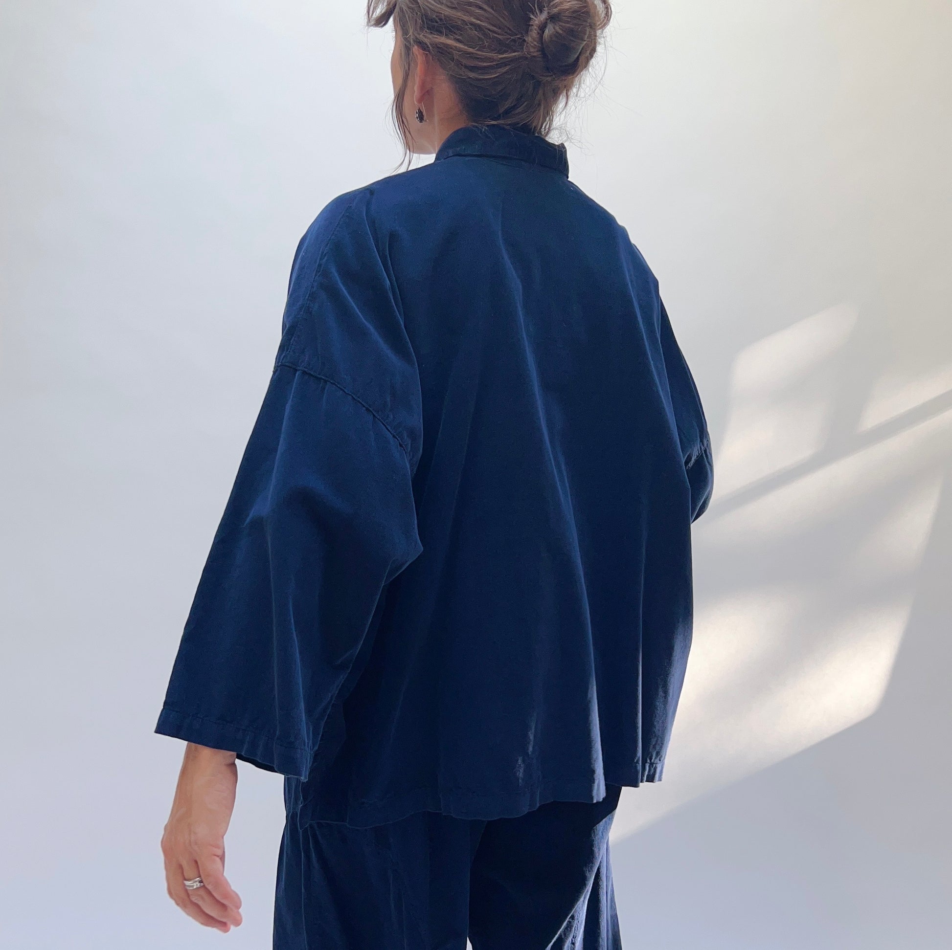 Back view of the Eleven Stitch Corduroy Big Shirt in Indigo, showing wide boxy cut and three-quarter sleeves