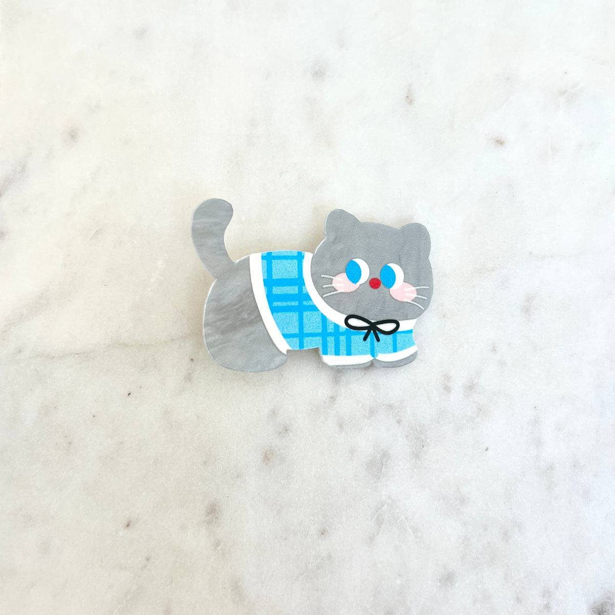 Cat-shaped hair clip with a blue checkered pattern on a white background