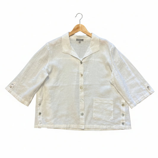 Habitat white linen-cotton button down shirt on a hanger, featuring agoya shell buttons at the placket and sleeves, a front patch pocket, and side button details