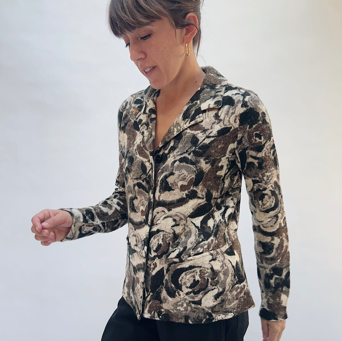 Habitat Aspen Peplum Jacket in Black, front three-quarter view showing the notch lapel collar, button-front closure, and abstract floral print in black, taupe, and cream
