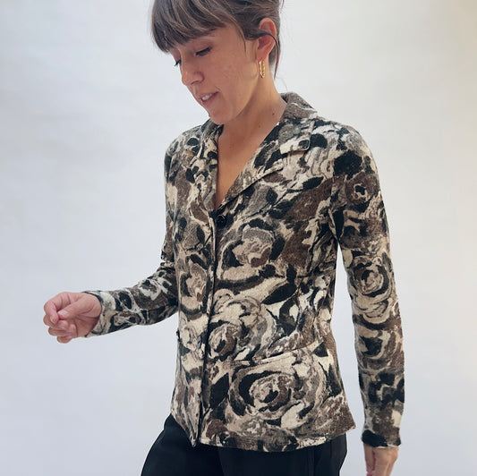 Habitat Aspen Peplum Jacket in Black, front three-quarter view showing the notch lapel collar, button-front closure, and abstract floral print in black, taupe, and cream
