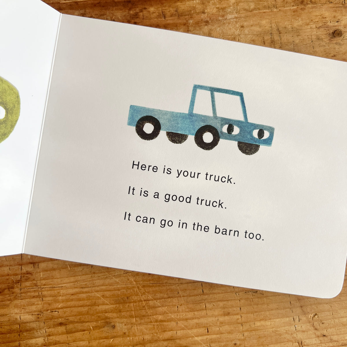 Open pages of Your Farm showing a blue truck with eyes above the words “Here is your truck. It is a good truck. It can go in the barn too.”
