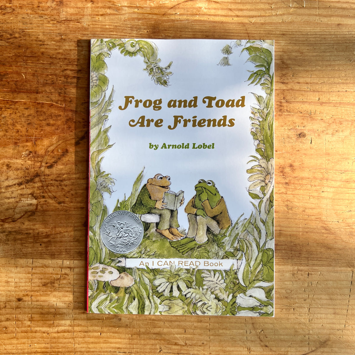 Paperback cover of Frog and Toad Are Friends by Arnold Lobel, showing the friends reading together among plants.
