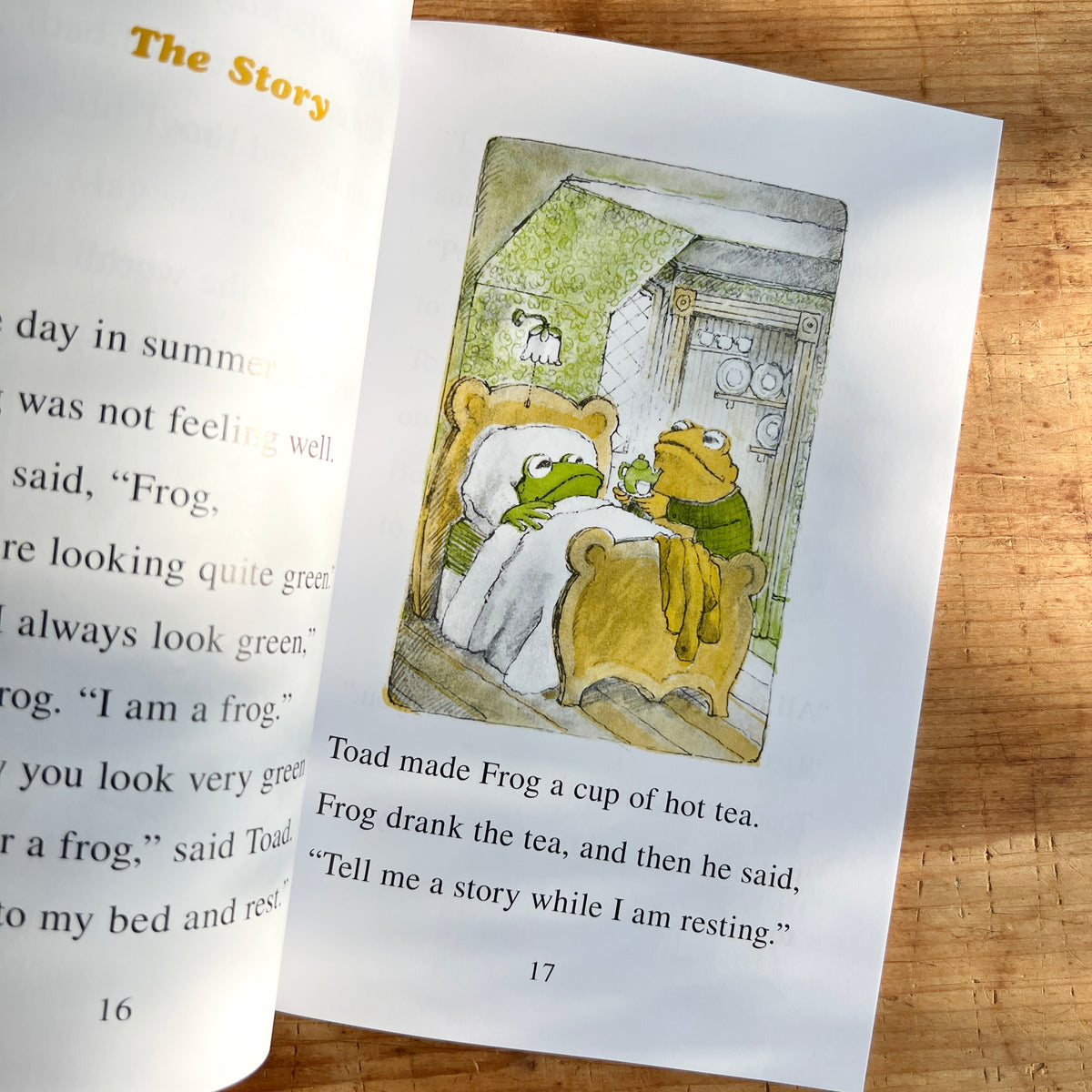 Open pages of Frog and Toad Are Friends showing Toad bringing a cup of tea to Frog as he rests in bed.
