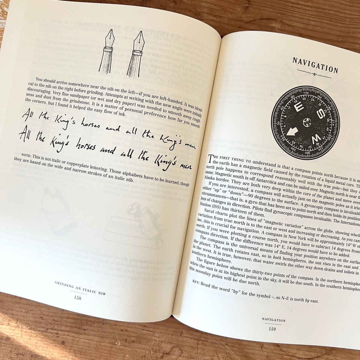 Open pages of The Dangerous Book for Boys showing pen nib illustrations, handwriting samples, and a navigation section with a compass.
