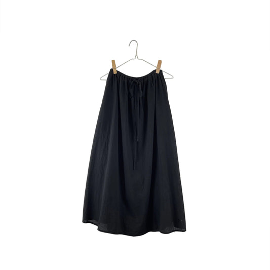 Black skirt on a hanger against a white background