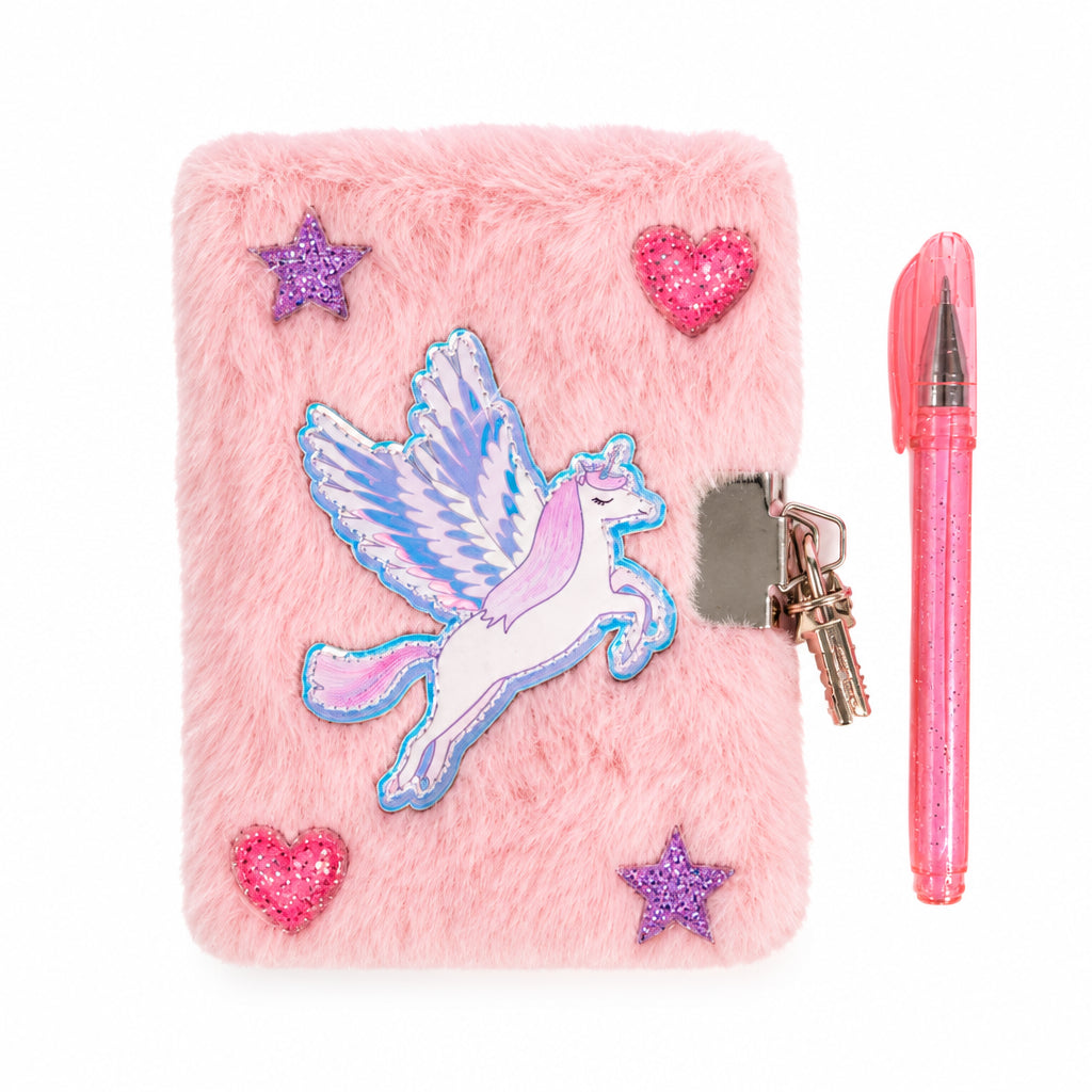 Great Pretenders Mini Furry Unicorn Journal with Lock and Pen, a pink faux fur journal with an iridescent winged unicorn appliqué and glitter star and heart accents, shown with a metal lock and key and a matching pink pen, on a white background. Measures 3.5 by 4.5 inches.
