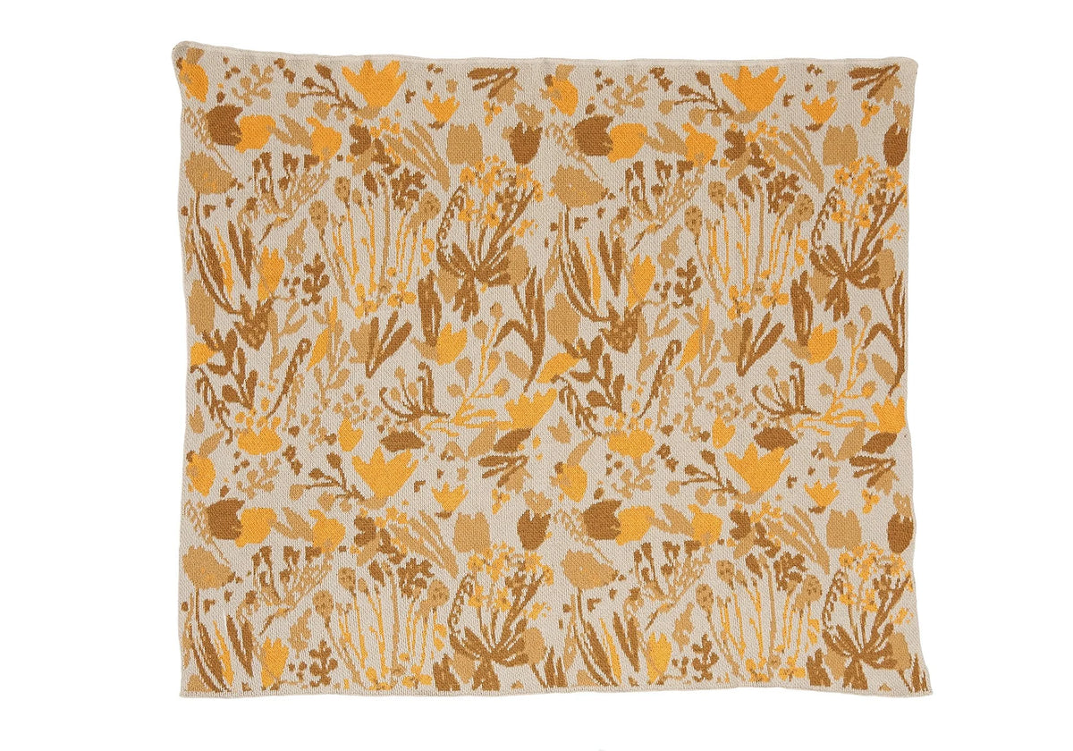 Poppies & Lotus Ocre child blanket laid flat, with golden yellow, tan, and brown flowers on a cream background.
