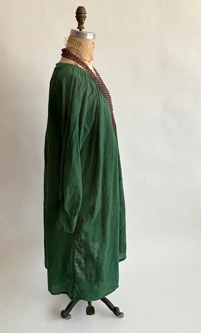 Side view of Olive Gathered Dress on a dress form, showing the loose drape and textured cotton khadi fabric.
