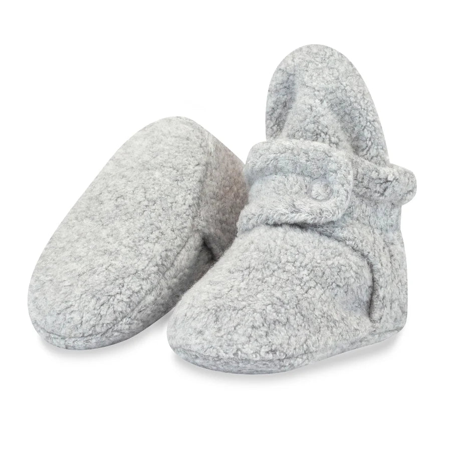 Heather Gray fleece baby booties, with one upright and the other tilted to show the plain fabric sole used in sizes 3M and 6M.
