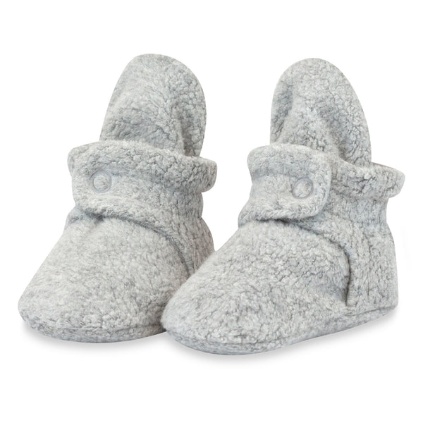 Pair of Zutano Heather Gray fleece baby booties shown upright, with wraparound ankle straps and snap closures.
