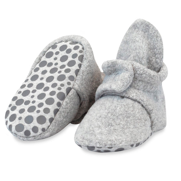 Heather Gray fleece baby booties, with one tilted to show the dotted gripper sole included in sizes 12M and 18M.
