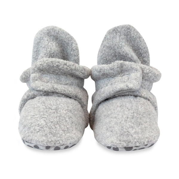 Front view of Heather Gray fleece baby booties with snap straps and dotted gripper soles, available in sizes 12M and 18M.
