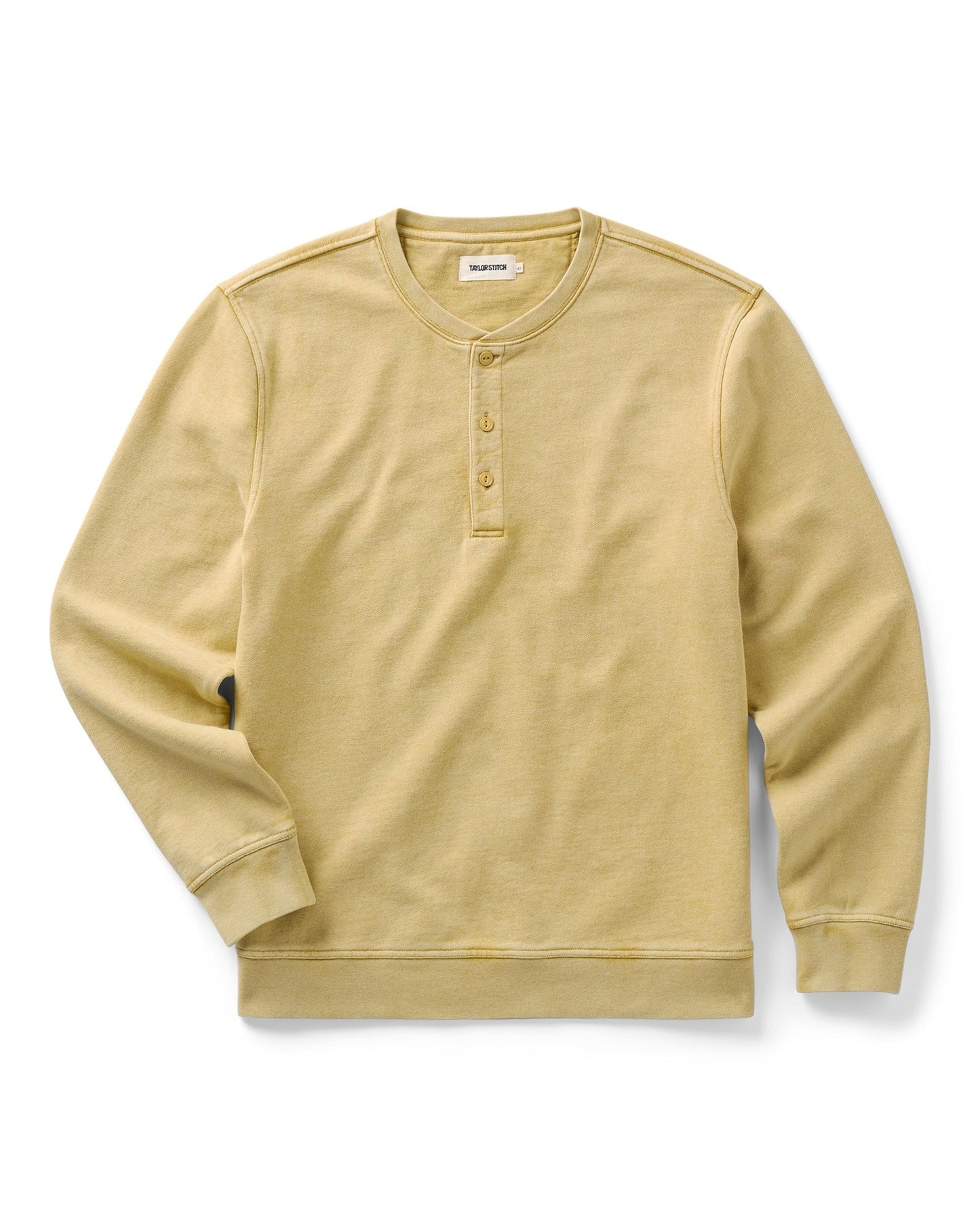 A pale yellow long-sleeve henley shirt with a three-button placket, laid flat against a white background.