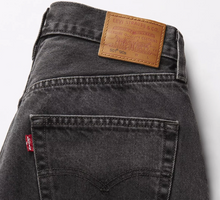 Load image into Gallery viewer, Close-up of a Levi&#39;s jeans back pocket with brand label on a white background
